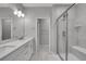Modern bathroom featuring dual sinks and a tiled walk-in shower with glass door at 6211 W 28Th Ct, Wheat Ridge, CO 80214