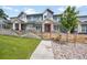 Attractive townhouse complex with blue siding, white trim, red doors, landscaping, and a walkway at 6211 W 28Th Ct, Wheat Ridge, CO 80214