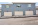 Attached two-car garages with classic panel design and concrete driveways at 6211 W 28Th Ct, Wheat Ridge, CO 80214