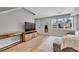 Bright living room features hardwood floors, modern decor, and a stylish wood media cabinet at 6211 W 28Th Ct, Wheat Ridge, CO 80214