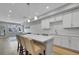 The bright living area features a modern kitchen with an island and barstool seating at 6211 W 28Th Ct, Wheat Ridge, CO 80214