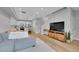 Bright open-concept living room featuring hardwood floors, a modern kitchen, and a comfortable sectional sofa at 6211 W 28Th Ct, Wheat Ridge, CO 80214
