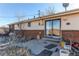 Back patio with brick siding, a sliding glass door, and a small window at 18199 E 160Th Ave, Brighton, CO 80601
