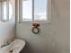 Retro bathroom featuring textured walls, round mirror, and a dated sink at 18199 E 160Th Ave, Brighton, CO 80601