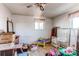 A cluttered bedroom with vintage carpets, a single window, and toys needs organization and renovation at 18199 E 160Th Ave, Brighton, CO 80601