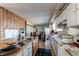 Kitchen area with white cabinets, tile floors, and older appliances at 18199 E 160Th Ave, Brighton, CO 80601