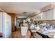 Large kitchen with white cabinets, tile floors, brick oven and counter cluttered with housewares at 18199 E 160Th Ave, Brighton, CO 80601