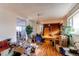 A spacious living room needing some TLC, featuring hardwood flooring, and views into the kitchen area at 18199 E 160Th Ave, Brighton, CO 80601