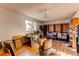 A living room interior with light fixtures, bookshelf, boxes, and hardwood flooring at 18199 E 160Th Ave, Brighton, CO 80601