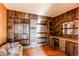 A uniquely wood-paneled living room with built-in shelves and a small bar is ready for remodeling at 18199 E 160Th Ave, Brighton, CO 80601