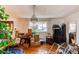 Chandelier in a large living room with boxes and plants obstructing the window view at 18199 E 160Th Ave, Brighton, CO 80601