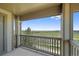 Serene covered balcony showcases scenic views of lush green field with open sky at 23451 E 5Th Dr # 203, Aurora, CO 80018