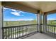 Relaxing covered balcony with railing, offering expansive views of green field at 23451 E 5Th Dr # 203, Aurora, CO 80018