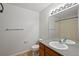 Clean bathroom with vanity, framed mirror, and shower-tub combo with updated fixtures at 23451 E 5Th Dr # 203, Aurora, CO 80018