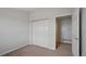 Bedroom with closet and door leading to the en-suite bathroom at 23451 E 5Th Dr # 203, Aurora, CO 80018