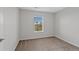 Neutral bedroom with large window offering natural light and neighborhood views at 23451 E 5Th Dr # 203, Aurora, CO 80018