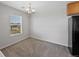 Bright dining area featuring modern chandelier, neutral walls, and large window with neighborhood view at 23451 E 5Th Dr # 203, Aurora, CO 80018