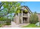 Inviting two-story condo featuring brick accents, dual balconies, and landscaped grounds at 23451 E 5Th Dr # 203, Aurora, CO 80018