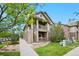 Inviting two-story condo featuring brick accents, dual balconies, and landscaped grounds at 23451 E 5Th Dr # 203, Aurora, CO 80018