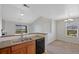Open kitchen flows to eating area, featuring granite counters, stainless sink, and modern black appliances at 23451 E 5Th Dr # 203, Aurora, CO 80018