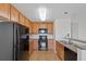 Efficient kitchen with black appliances, and granite countertops at 23451 E 5Th Dr # 203, Aurora, CO 80018