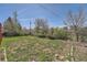 This grassy backyard has trees and bushes along the fence line, providing privacy at 13086 E Alaska Ave, Aurora, CO 80012