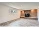 Basement featuring exposed brick, neutral paint, and plank flooring, an inviting bonus space at 13086 E Alaska Ave, Aurora, CO 80012
