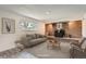 Cozy basement with brick fireplace, gray sofa and wood flooring, offering a relaxing retreat at 13086 E Alaska Ave, Aurora, CO 80012