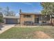 This home boasts a charming brick facade, gray accents, and a well-manicured lawn at 13086 E Alaska Ave, Aurora, CO 80012