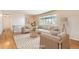 Bright living room featuring hardwood floors, large window, comfortable seating, and stylish decor at 13086 E Alaska Ave, Aurora, CO 80012