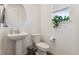 Cozy powder room with a pedestal sink, modern fixtures, and a bright window at 13220 E 110Th Pl, Commerce City, CO 80022