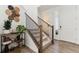 Inviting entryway featuring hardwood floors, stairs with black iron spindles, and stylish decor at 13220 E 110Th Pl, Commerce City, CO 80022