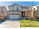 Charming two-story home with a two-car garage and well-maintained lawn on a sunny day at 13220 E 110Th Pl, Commerce City, CO 80022