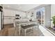 Bright kitchen and dining area with white cabinetry, stainless steel appliances, and natural light at 13220 E 110Th Pl, Commerce City, CO 80022