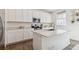 Modern kitchen featuring white cabinets, a quartz countertop island, and stainless steel appliances at 13220 E 110Th Pl, Commerce City, CO 80022