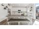 Bright kitchen and dining area with white cabinetry, stainless steel appliances, and table at 13220 E 110Th Pl, Commerce City, CO 80022