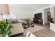 Cozy living room featuring a large couch, wooden coffee table, and a large television at 13220 E 110Th Pl, Commerce City, CO 80022