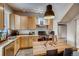 Bright kitchen featuring wooden cabinets, stainless steel appliances, and dining area at 3736 N Mariposa St, Denver, CO 80211