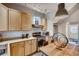 Well-lit kitchen features wooden cabinets, stainless steel appliances, and an adjacent dining area at 3736 N Mariposa St, Denver, CO 80211