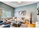 Inviting living room featuring a large sectional sofa and stylish decor against a blue accent wall at 3736 N Mariposa St, Denver, CO 80211