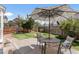 Backyard featuring a stone patio, well-maintained lawn, and mature landscaping at 19064 E Oak Creek Way, Parker, CO 80134