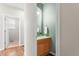 Charming powder room with wood vanity and ample lighting at 19064 E Oak Creek Way, Parker, CO 80134