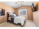 Cozy bedroom features a neutral color palette, a TV, and bright natural light at 19064 E Oak Creek Way, Parker, CO 80134