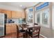 Bright dining area featuring wood floors, natural light, modern cabinets, and a chandelier at 19064 E Oak Creek Way, Parker, CO 80134