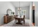 Dining room with a large table, chandelier, and decorative mirror at 19064 E Oak Creek Way, Parker, CO 80134