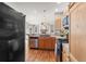 Well-lit kitchen featuring wooden cabinets, stainless steel appliances, and hardwood flooring at 19064 E Oak Creek Way, Parker, CO 80134