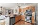 Kitchen featuring stainless steel appliances, wooden cabinets, and tiled countertops at 19064 E Oak Creek Way, Parker, CO 80134
