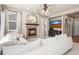Cozy living room featuring a fireplace, plush seating, and a ceiling fan at 19064 E Oak Creek Way, Parker, CO 80134