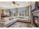Inviting living room with fireplace, plush seating, and access to the dining area at 19064 E Oak Creek Way, Parker, CO 80134
