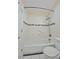Clean white tiled bathroom with a bathtub, shower, and coordinated fixtures at 9255 E Lehigh Ave # 194, Denver, CO 80237